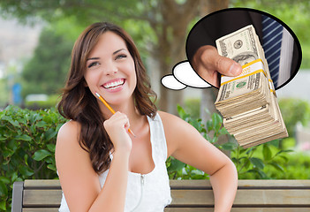 Image showing Thoughtful Young Woman with Hand Holding Stack of Money Inside T