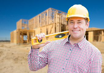 Image showing Smiling Male Contractor in Hardhat Holding Blueprints  and Level