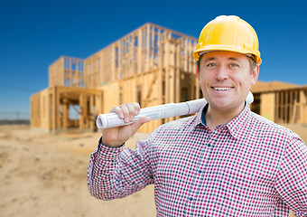 Image showing Smiling Contractor Wearing Hardhat Holding Blueprints at Home Co