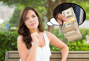 Image showing Thoughtful Young Woman with Hand Holding Stack of Money Inside T