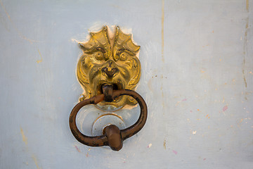 Image showing Old rusty metal door knocker on an old wooden entrance door