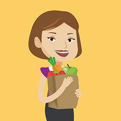 Image showing Happy woman holding grocery shopping bag.