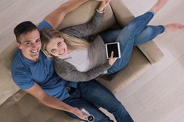 Image showing youg couple in living room with tablet top view