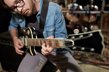 Image showing man playing guitar at studio rehearsal