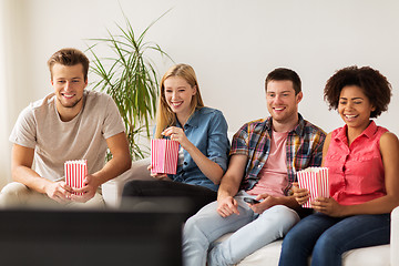 Image showing happy friends with popcorn watching tv at home