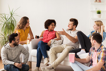 Image showing happy friends with popcorn and beer at home