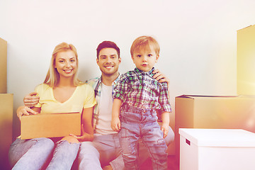 Image showing happy family with boxes moving to new home