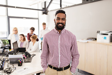 Image showing happy indian man over creative team in office