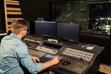 Image showing man at mixing console in music recording studio