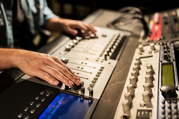 Image showing man using mixing console in music recording studio