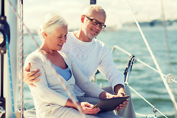 Image showing senior couple with tablet pc on sail boat or yacht