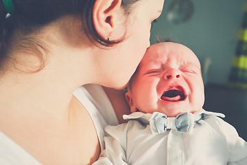 Image showing Mother holding crying baby