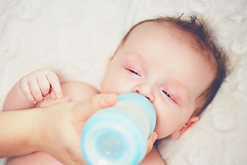 Image showing Hungry baby drinking milk