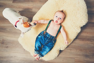 Image showing Little boy and dog at home