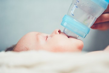 Image showing Hungry baby drinking milk