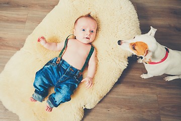 Image showing Little boy and dog at home