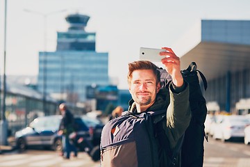 Image showing Traveler taking a selfie at the airport