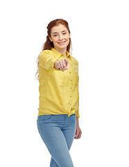 Image showing happy young woman pointing finger on you