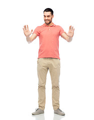 Image showing happy man touching something imaginary