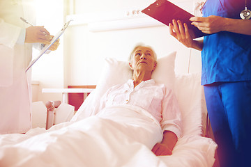 Image showing doctor and nurse visiting senior woman at hospital