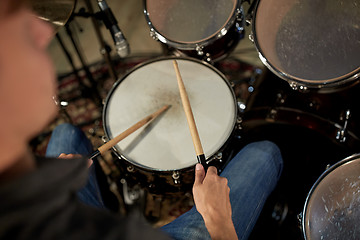 Image showing man playing drums at concert or music studio