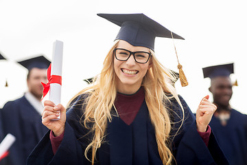 Image showing happy student with diploma celebrating graduation