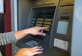 Image showing close up of hands choosing option on atm machine