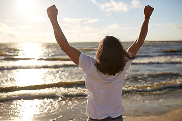 Image showing man with rised fist on beach