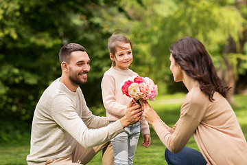 Image showing happy family with flowers in summer park