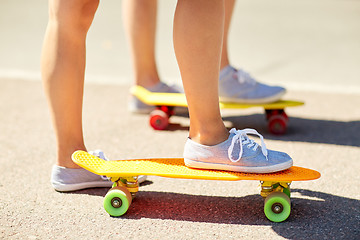 Image showing close up of female feet riding short skateboard