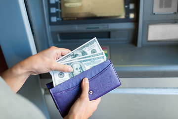 Image showing close up of hand withdrawing money at atm machine