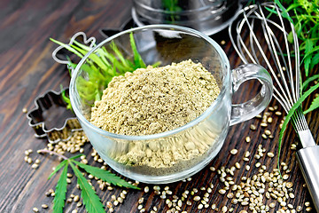 Image showing Flour hemp in glass cup on board