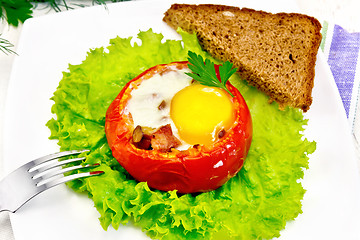 Image showing Scrambled eggs in tomato on board