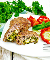 Image showing Cutlets stuffed with vegetables in plate on light board