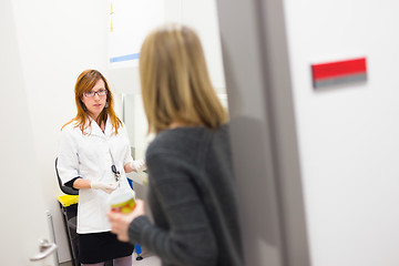 Image showing Young researcher and her supevisor discussing research project details in scientific laboratory.