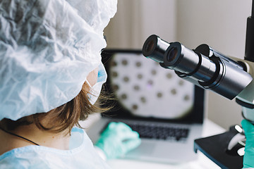 Image showing Female scientist working on laptop in laboratory.