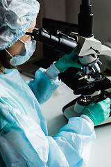 Image showing Scientist working in laboratory with microscope