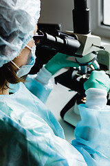 Image showing Scientist working in laboratory with microscope