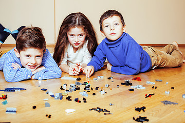 Image showing funny cute children playing lego at home, boys and girl smiling, first education role lifestyle