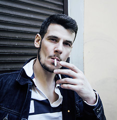 Image showing middle age man smoking cigarette on bacyjard, stylish tough guy,