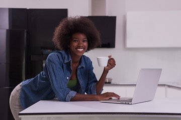 Image showing smiling black woman in modern kitchen