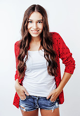 Image showing young pretty teenage hipster girl posing emotional happy smiling on white background, lifestyle people concept