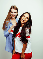 Image showing best friends teenage girls together having fun, posing emotional on white background, besties happy smiling, lifestyle people concept, blond and brunette multi nations 