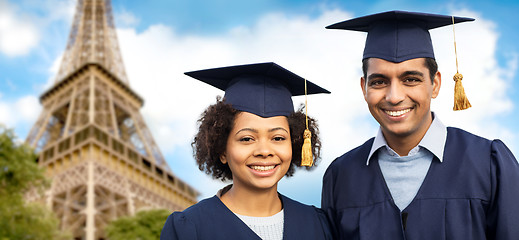 Image showing happy students or bachelors over eiffel tower