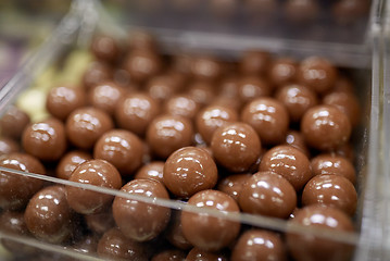 Image showing close up of chocolate dragee candies in box