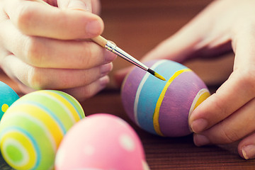 Image showing close up of woman hands coloring easter eggs