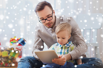 Image showing father and son with tablet pc playing at home