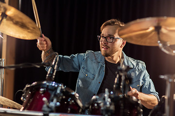 Image showing male musician playing drums and cymbals at concert