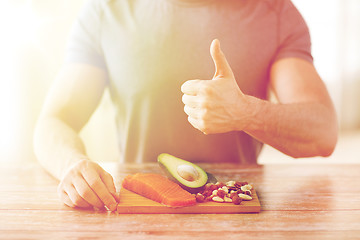 Image showing close up of male hands with food rich in protein