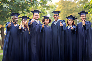 Image showing happy students or bachelors showing thumbs up